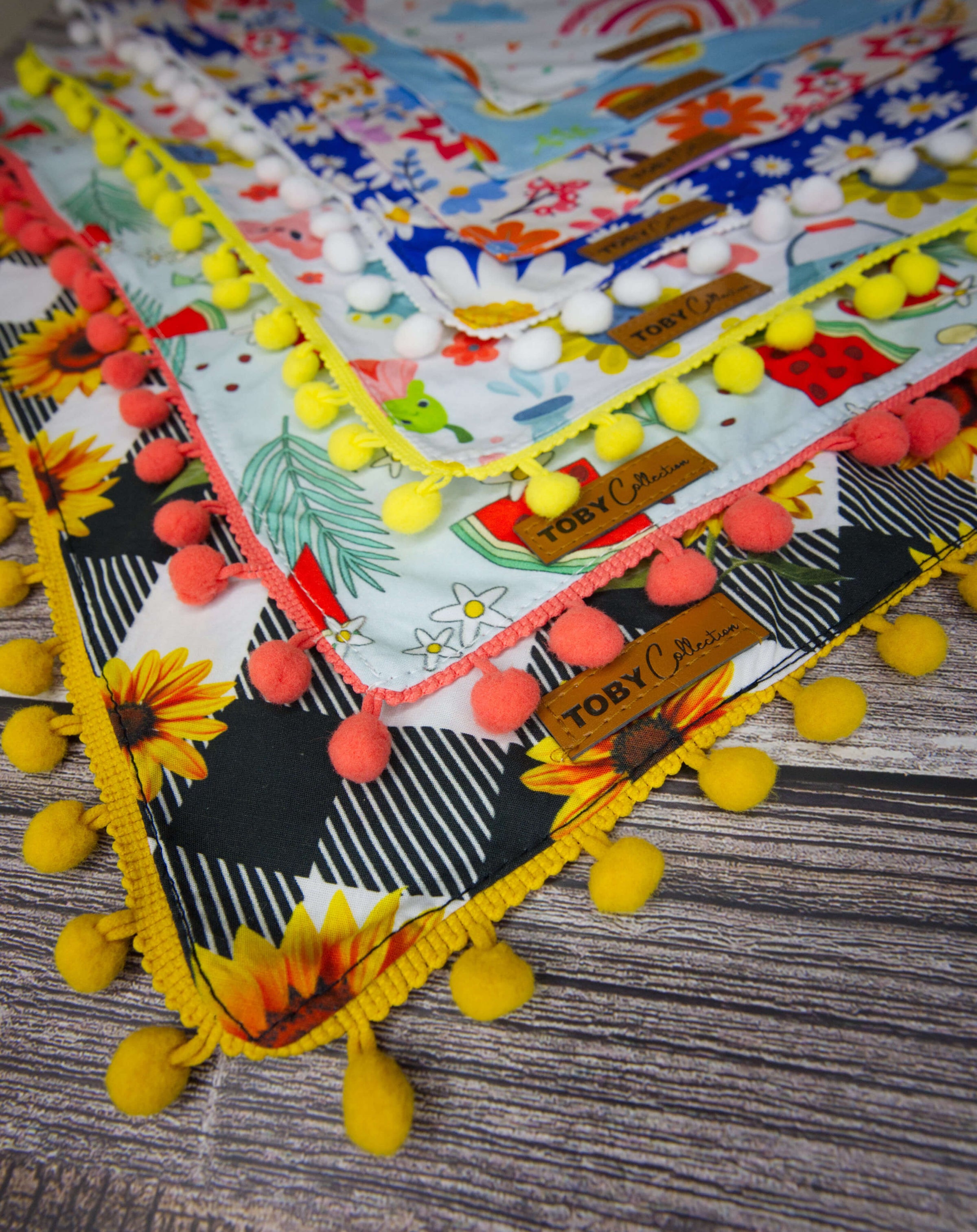 A variety of premium 100% cotton, double-sided dog bandanas in various patterns by Toby Collection. High-quality pet accessories shipping worldwide.