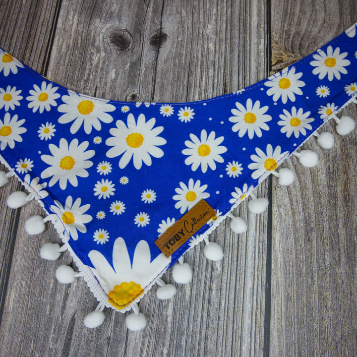 Dog bandana with daisy pattern on a wooden surface