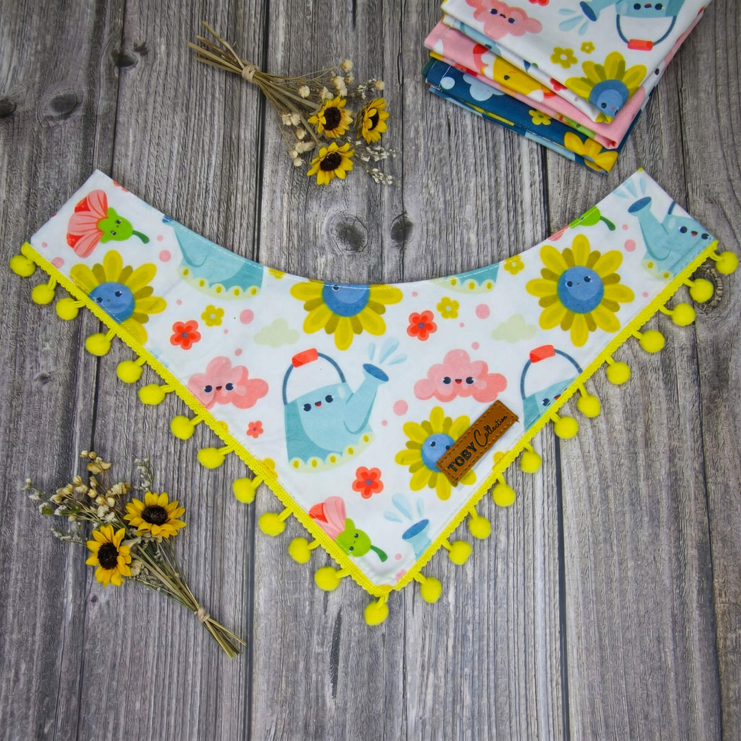 Children's bandana bib with cartoon designs on a wooden surface