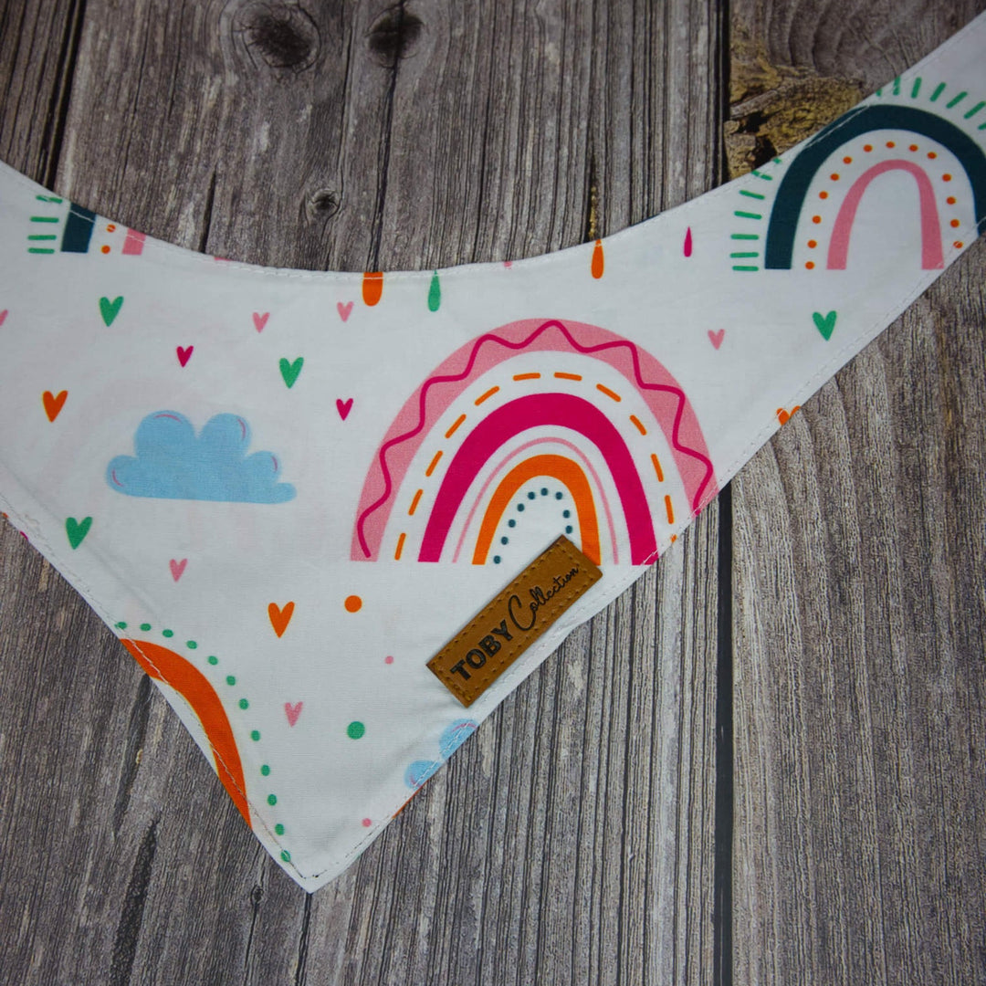 Colorful bib with rainbow design on a wooden surface