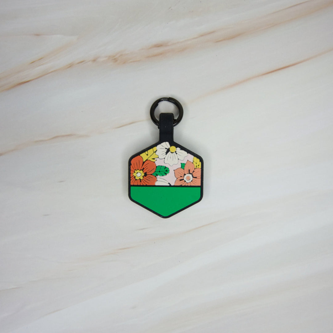 A personalized Toby Collection hexagonal dog tag with a floral design 