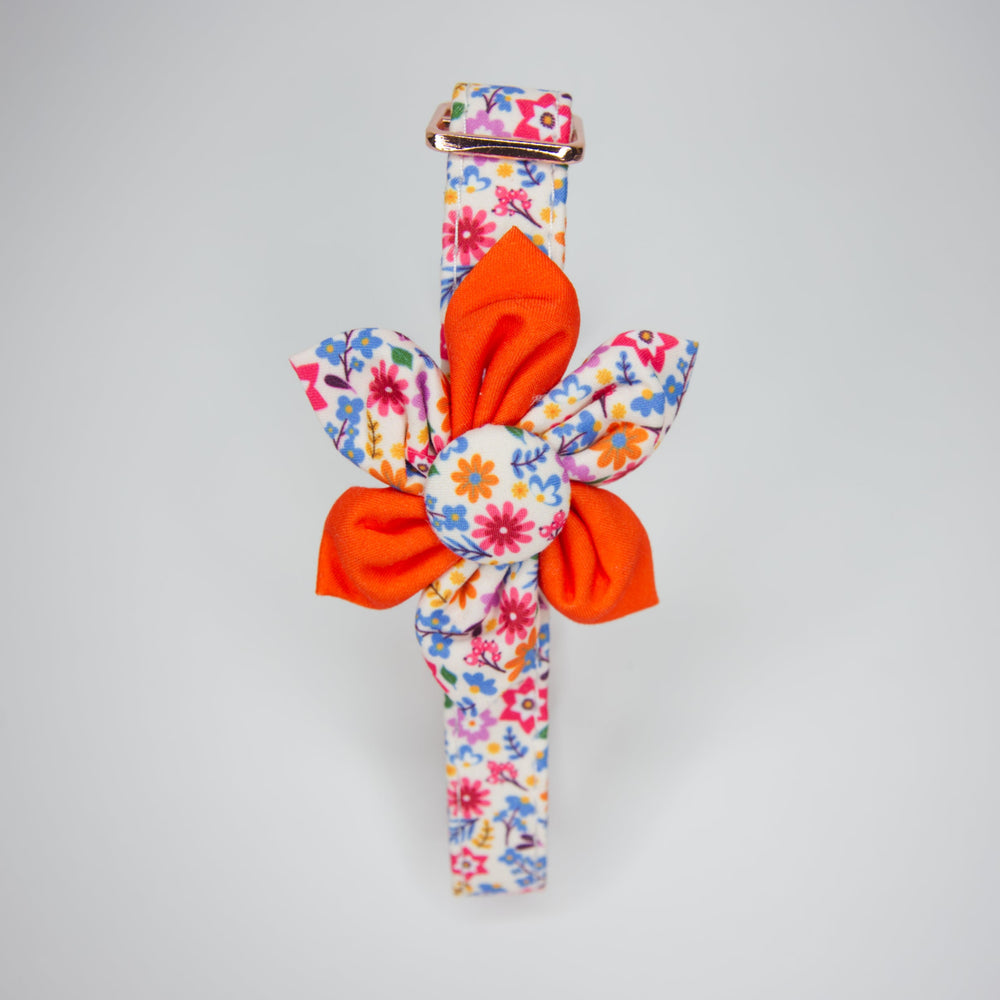 Adjustable dog collar with a yellow and orange flower design, featuring a checkered pattern with sunflowers and a metal buckle.