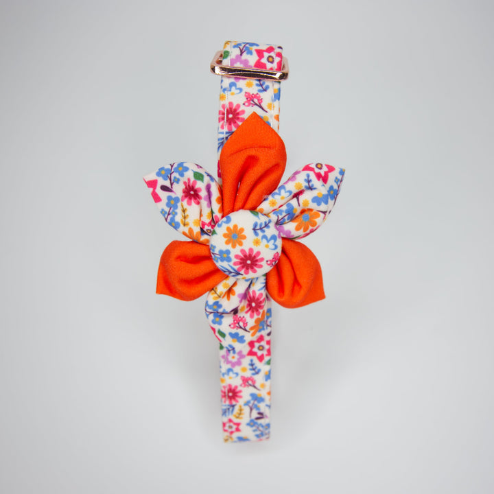 Adjustable dog collar with a yellow and orange flower design, featuring a checkered pattern with sunflowers and a metal buckle.