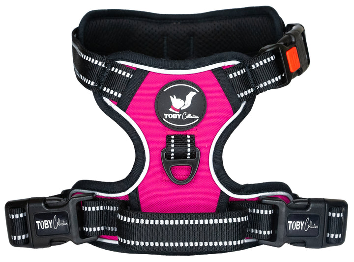 Close-up of a pink Toby Collection no-pull dog harness, showing the reflective stitching and durable buckles.