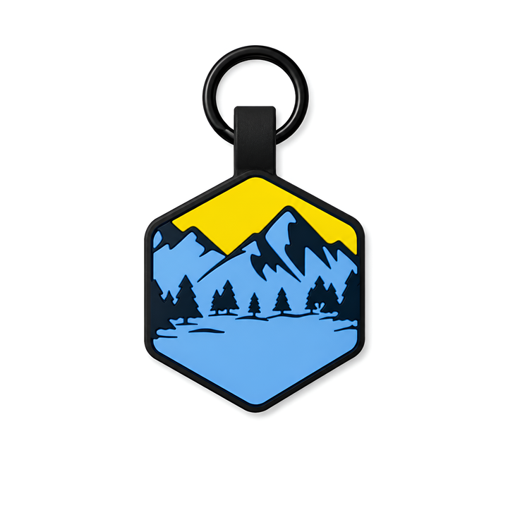 Hexagonal dogtag with mountain and tree design on a white background