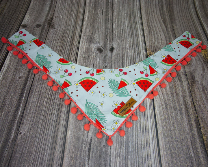 Toby Collection watermelon print dog bandana on a rustic wooden base.