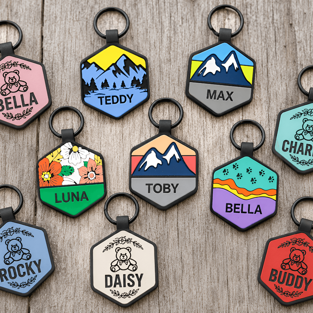 Collection of personalized pet tags with names on a wooden surface